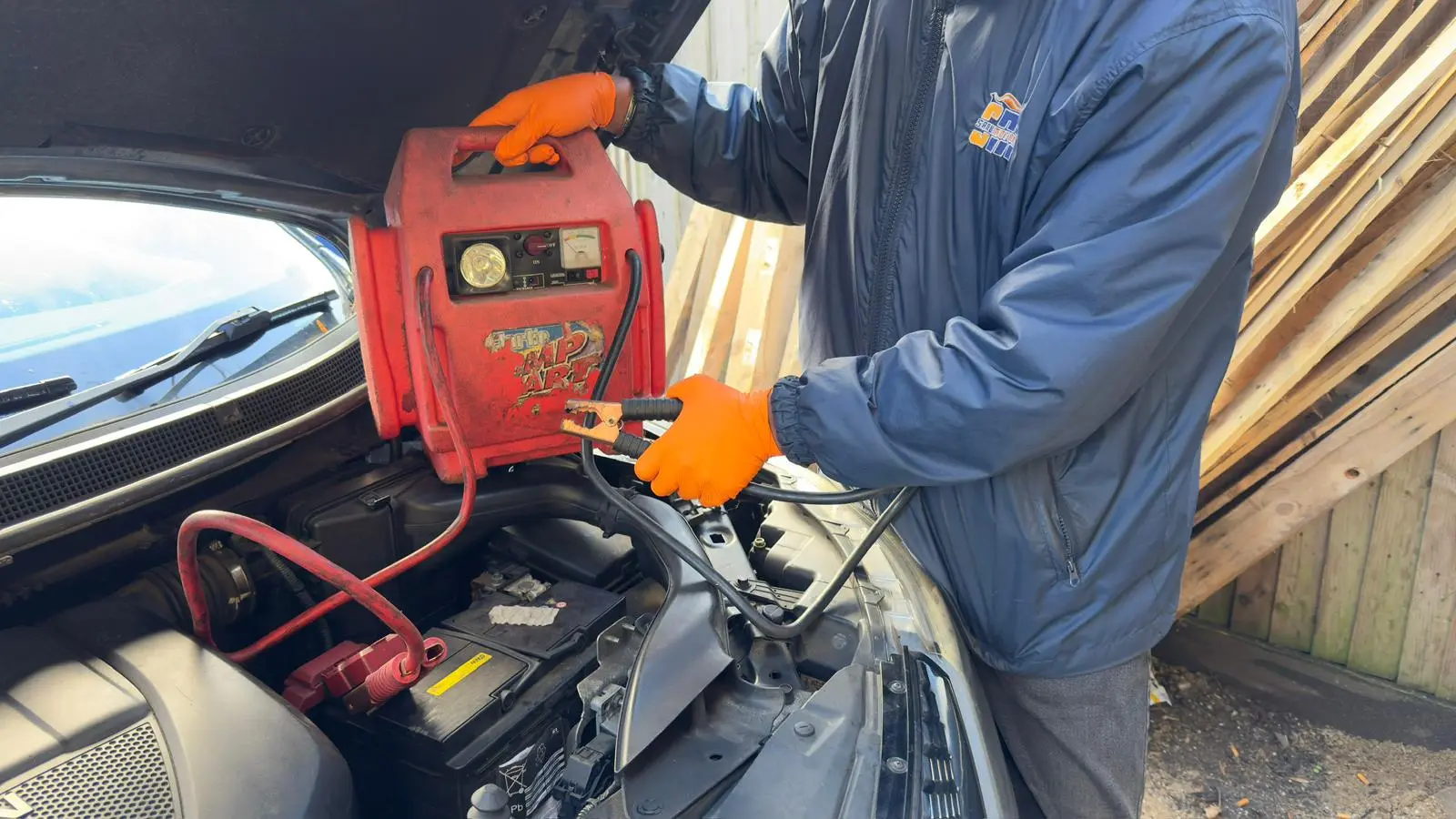 Using a portable jump starter pack to start a car battery